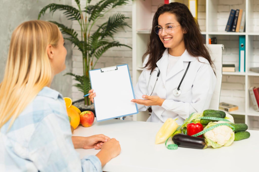 a woman in a doctor's coat sitting at a table with a clipboard