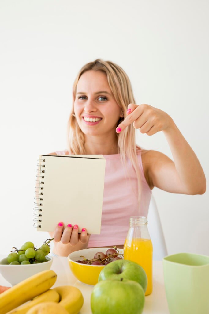 a woman pointing at a notebook